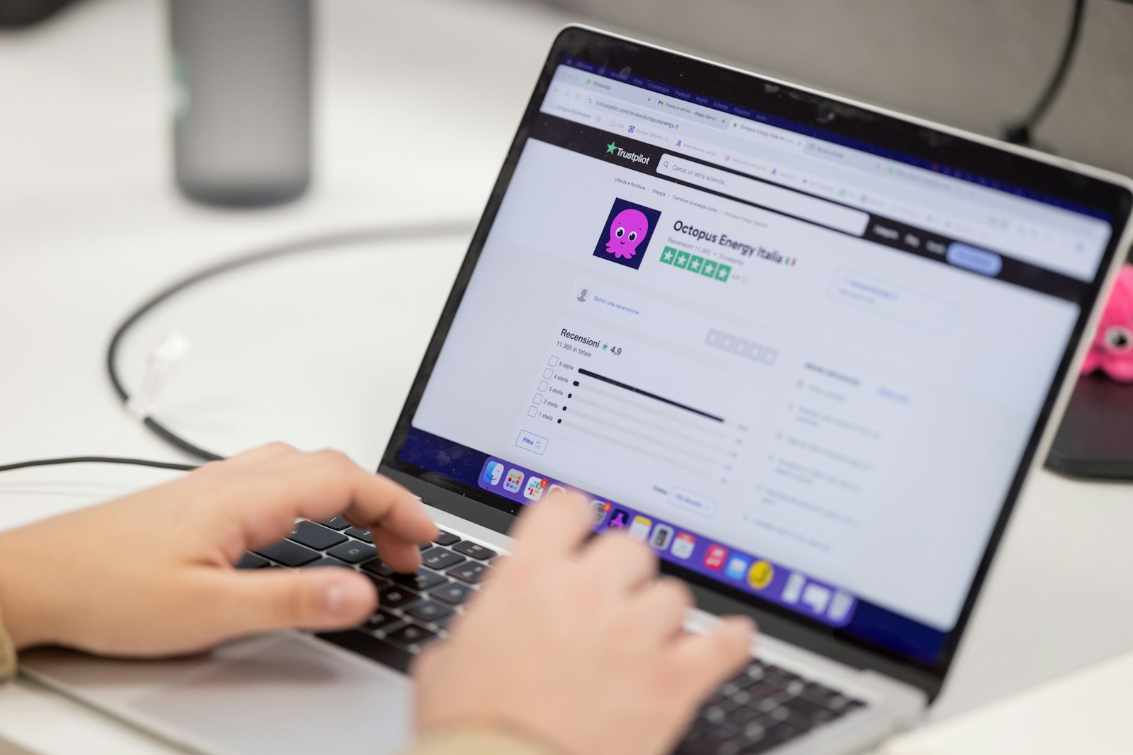 Person typing on a laptop computer screen.