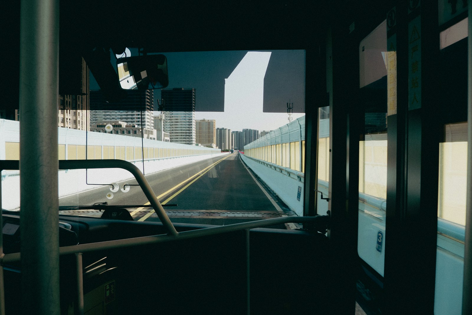 View from a bus looking out at a city street.
