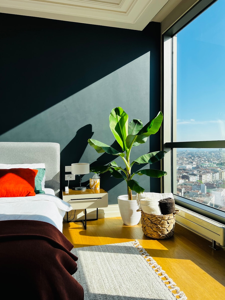 a bedroom with a large window overlooking a city